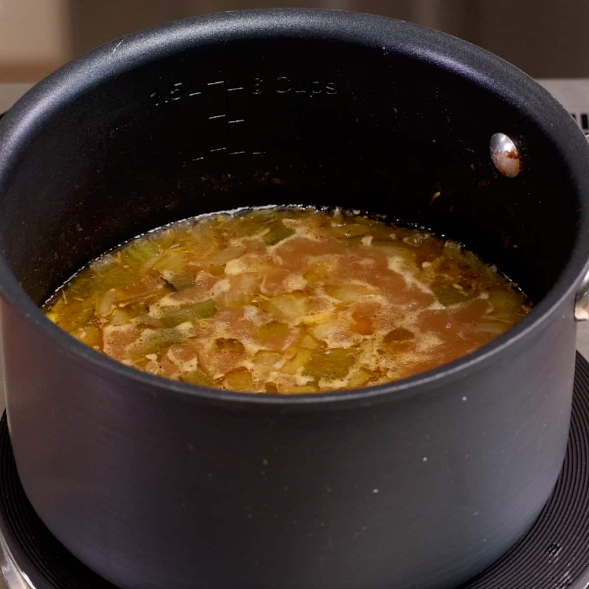 a pot of gumbo simmering on the stove
