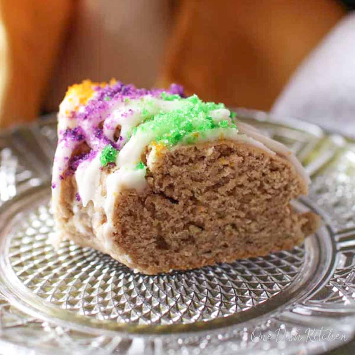 a king cake scone on a plate.