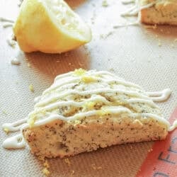 a lemon scone with a glaze on a baking sheet.