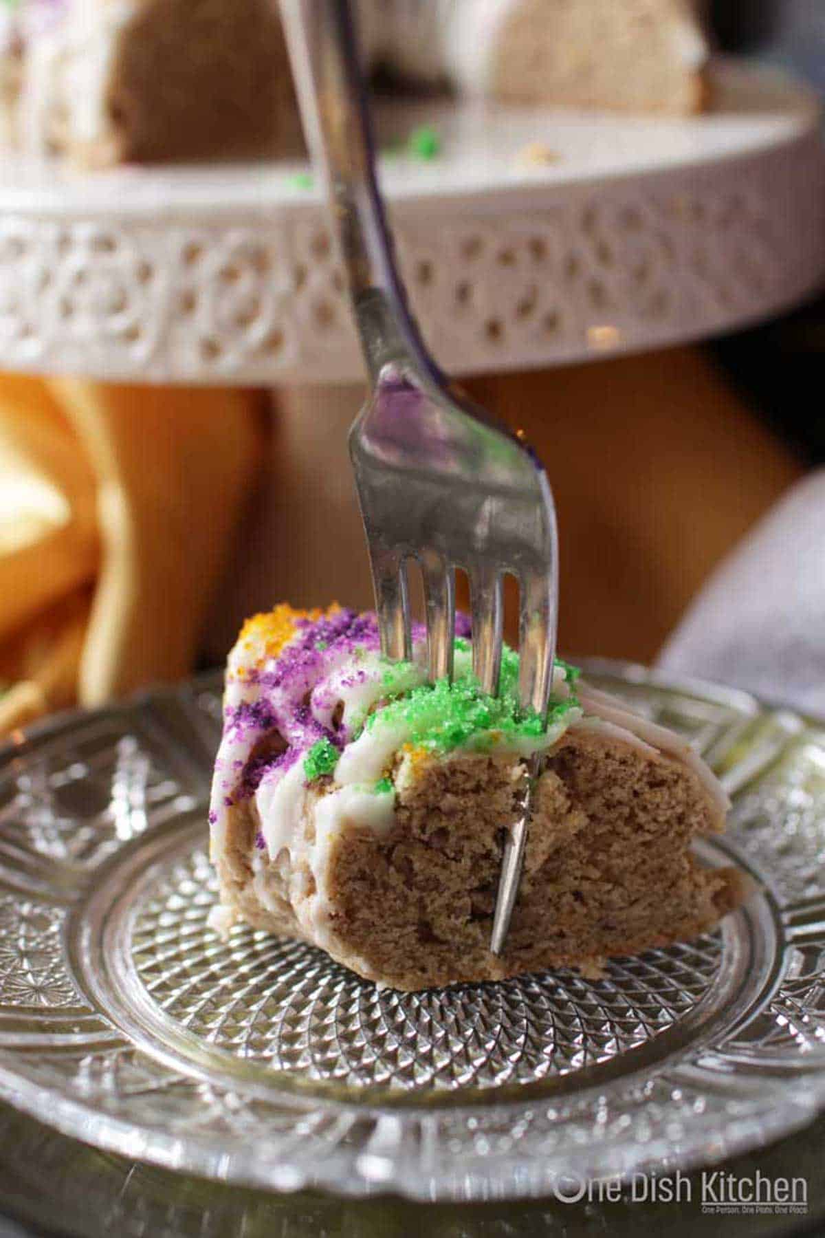 a king cake scone with a fork on the side.