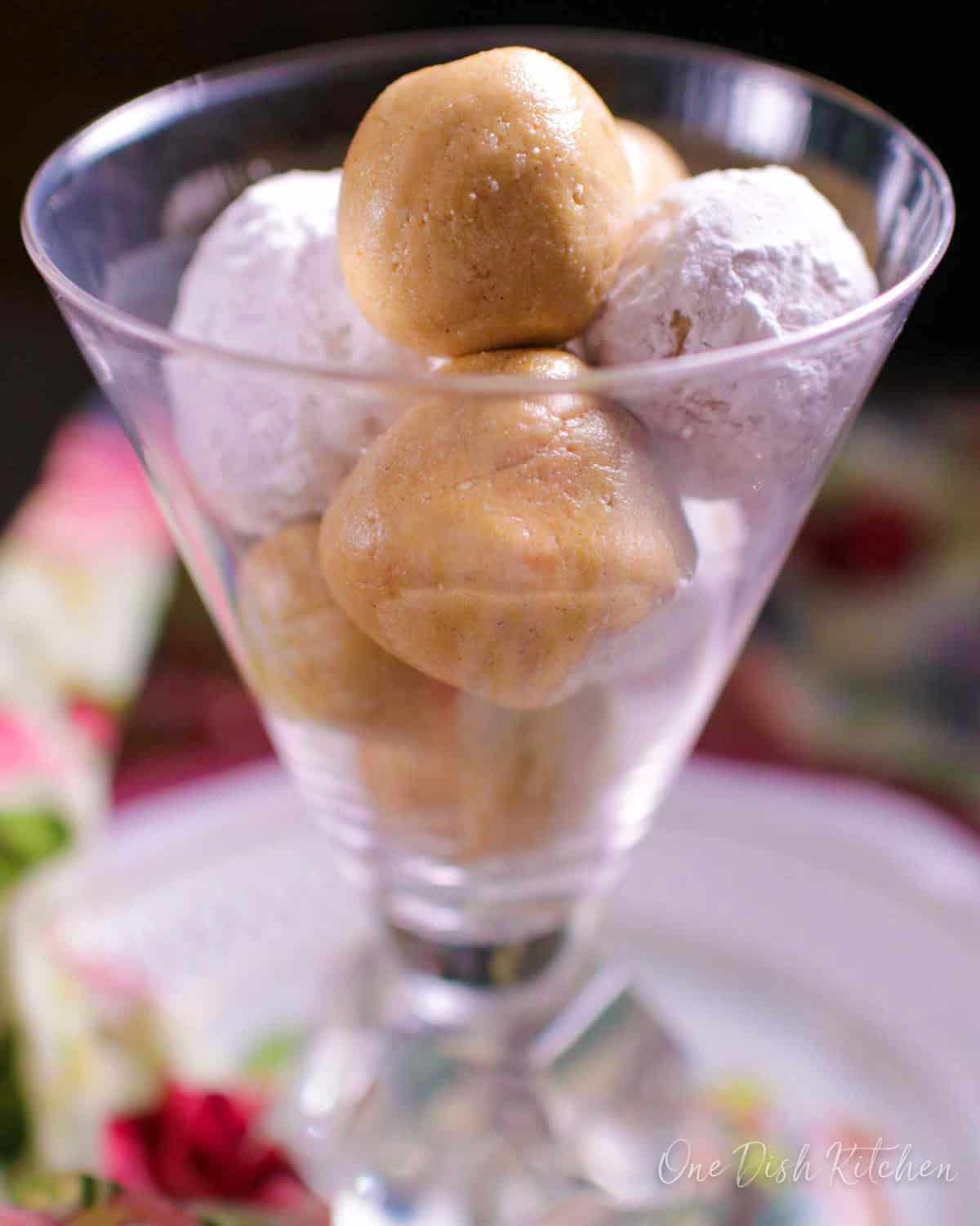 Peanut butter balls stacked in a dessert dish.