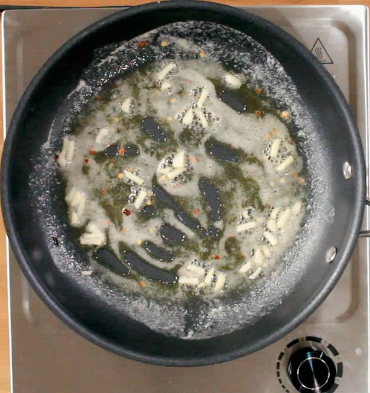 garlic cooking in butter in a small skillet