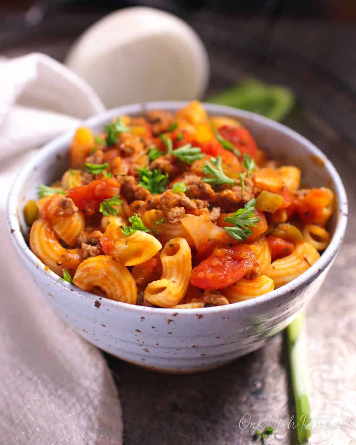 a single serving of american goulash with ground beef and elbow macaroni in a tomato sauce.