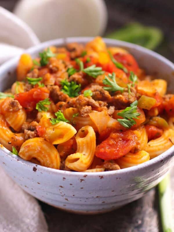 a single serving of american goulash with ground beef and elbow macaroni in a tomato sauce.