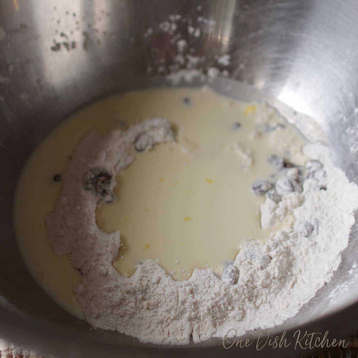 Egg yolk and buttermilk added to the mixture in the large bowl.