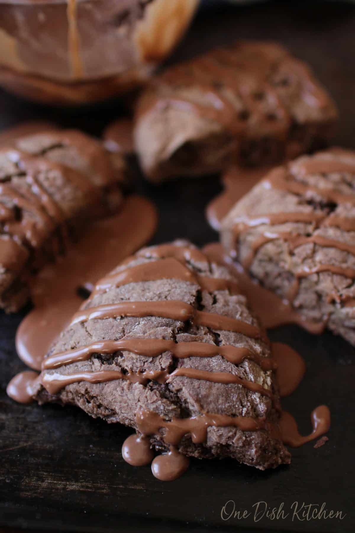 Chocolate scones with chocolate glaze dripping off the sides.