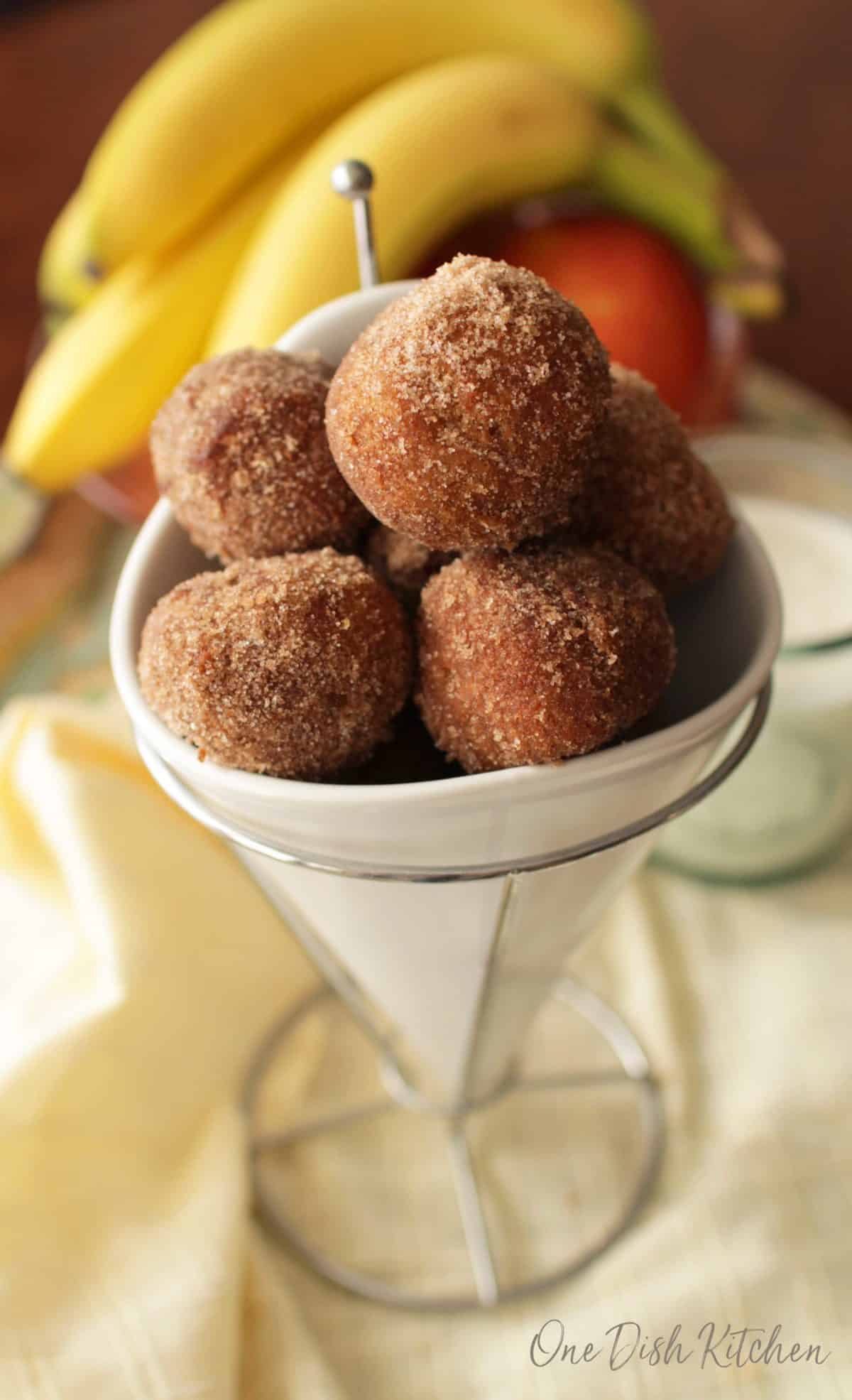 A closeup of a bowl of cinnamon sugar donut holes 