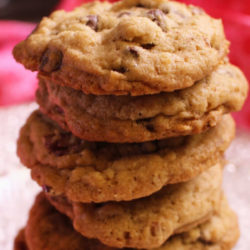 5 doubletree chocolate chip cookies piled on top of one another on a white plate
