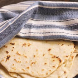 flour tortillas wrapped in a blue and white napkin