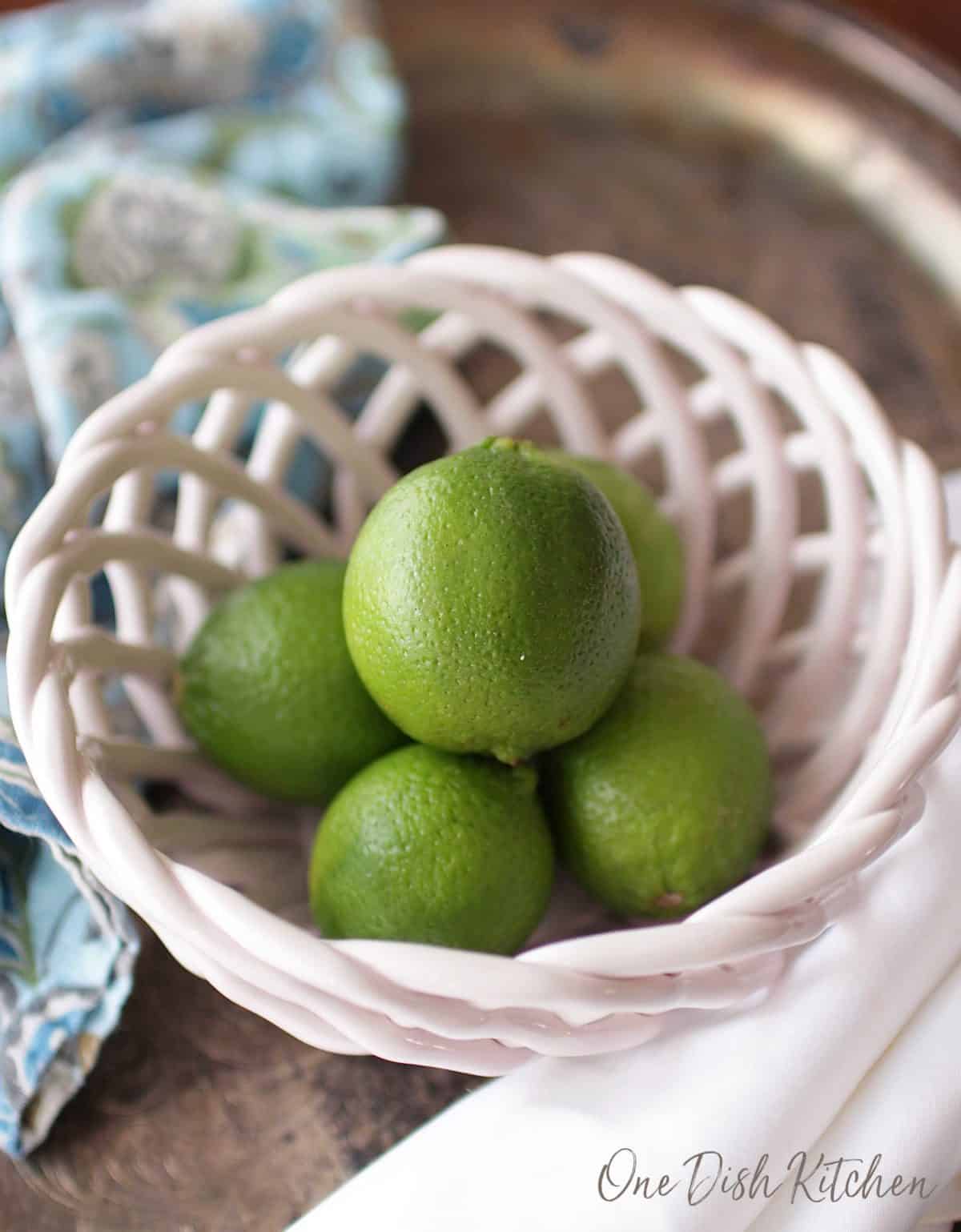 A bowl of five limes.