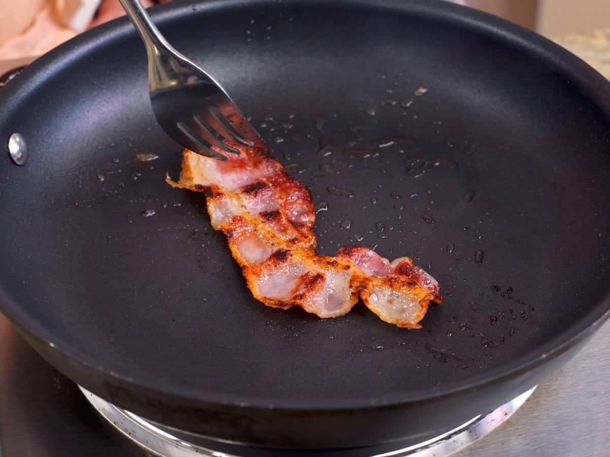 bacon cooking in a skillet.