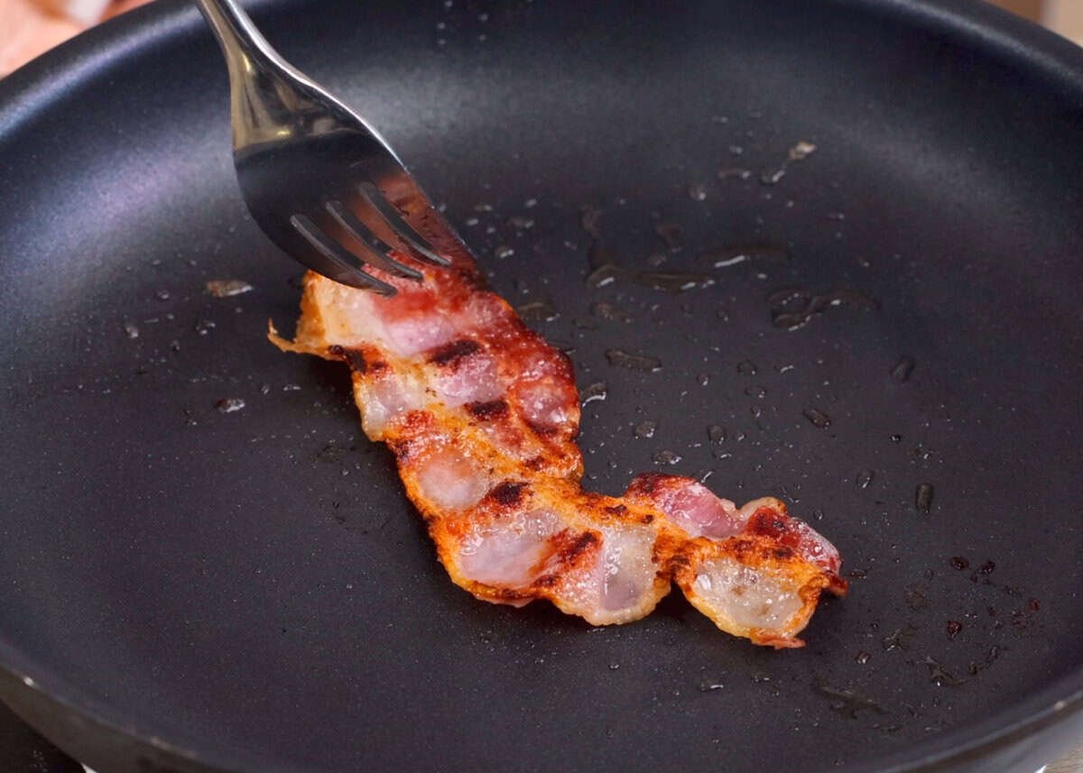 bacon cooking in a skillet.