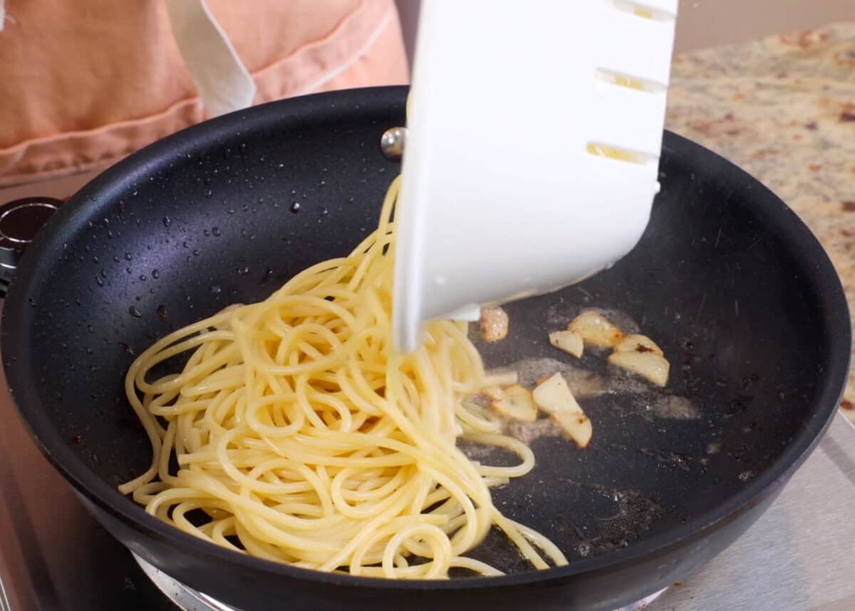 pasta added to a hot skillet.