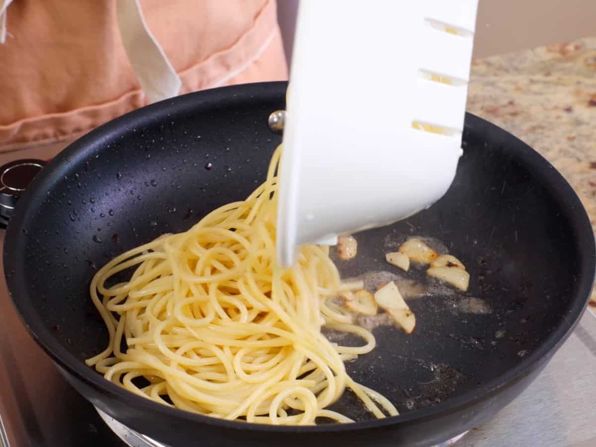 pasta added to a hot skillet.