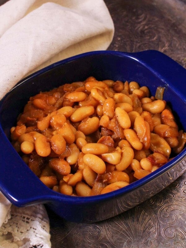 a bowl of baked beans with bacon.