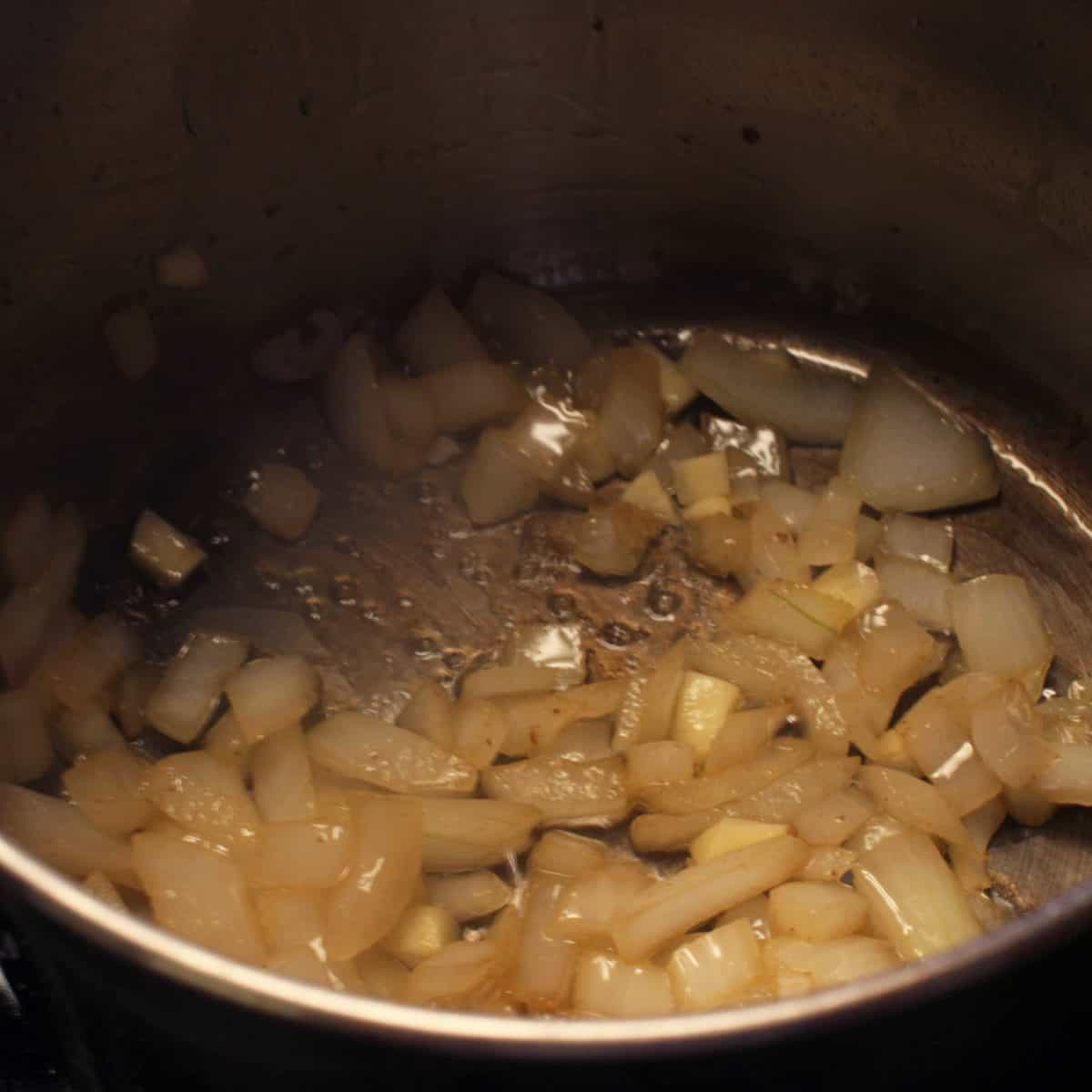 chopped onions cooking in a pot.