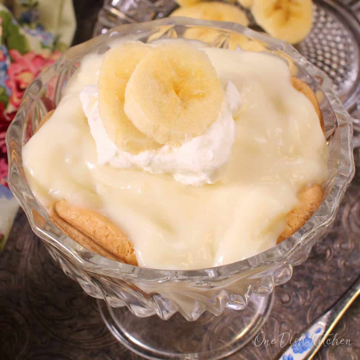 a single serving of banana cream pie with homemade pudding, banana slices, and whipped cream.