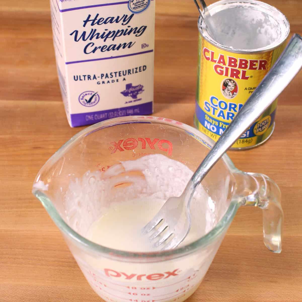 cornstarch and heavy cream in a bowl used to thicken banana cream pie.