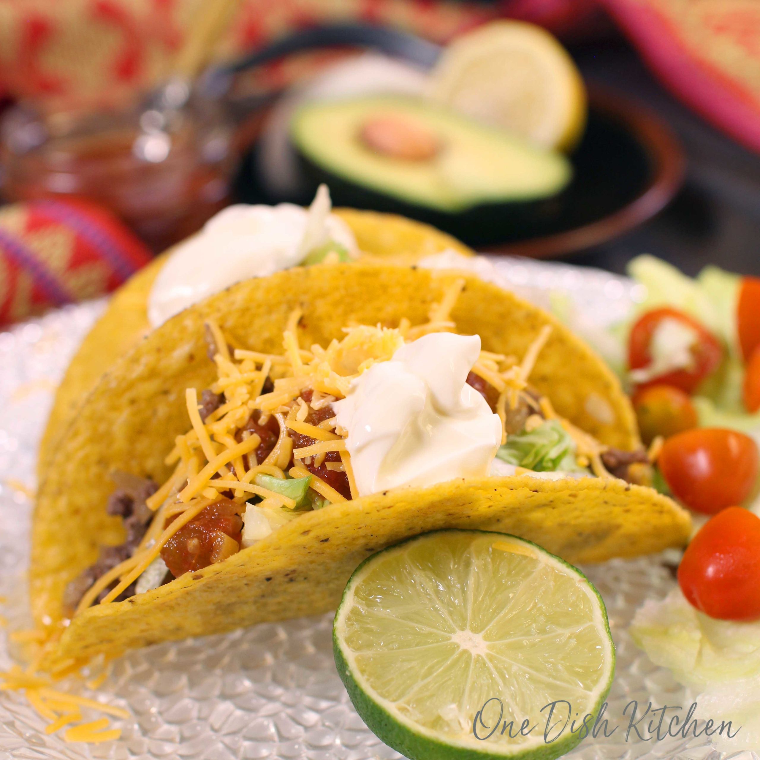 two beef tacos on a white plate.