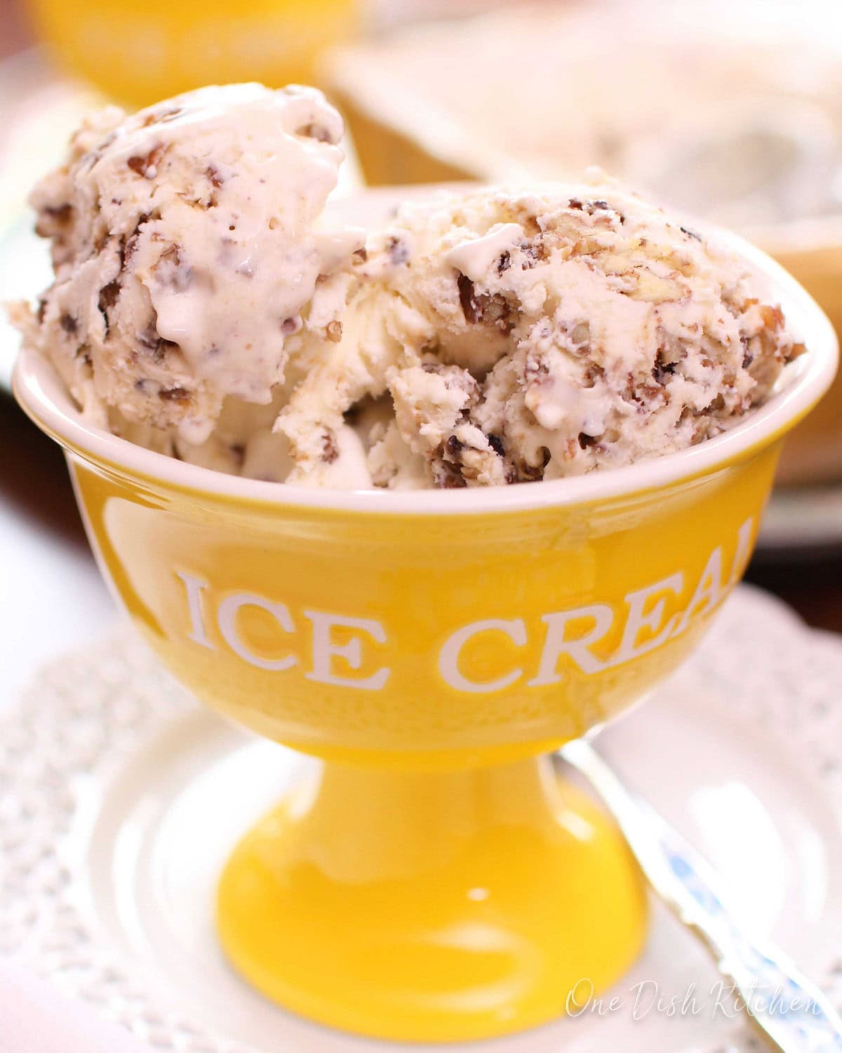 a yellow bowl filled with butter pecan ice cream.