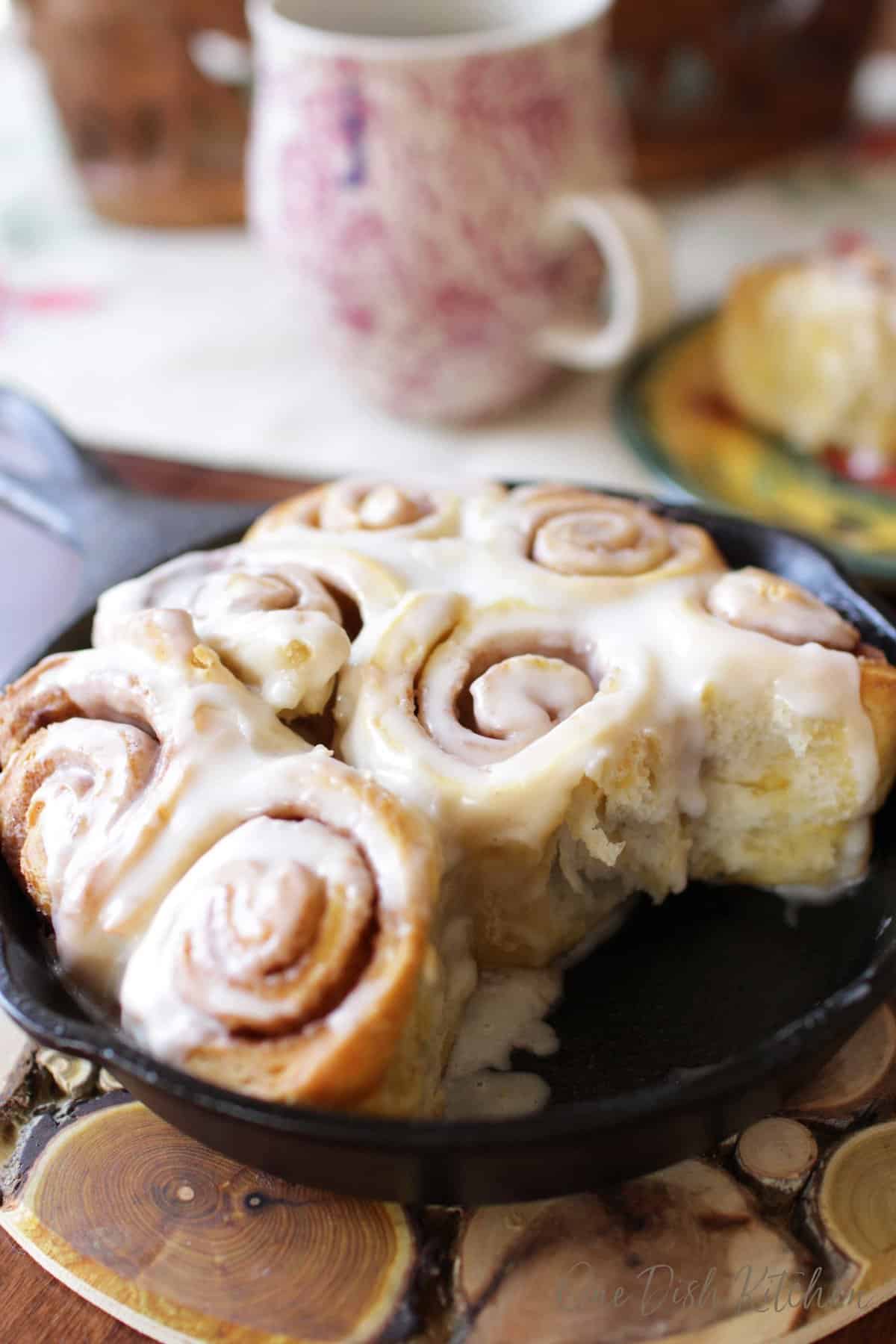a small cast iron skillet filled with homemade cinnamon rolls.