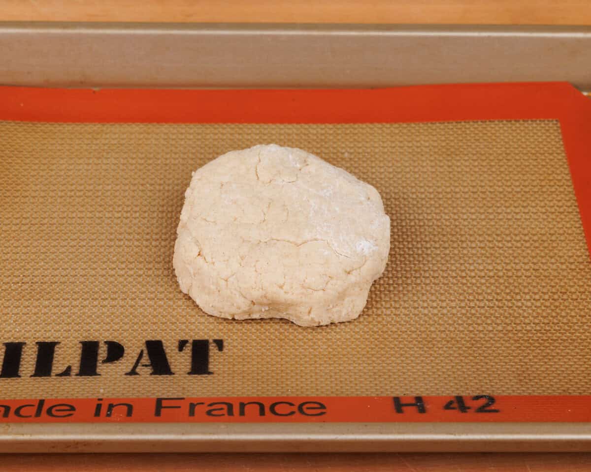 a round unbaked shortbread on a baking sheet.