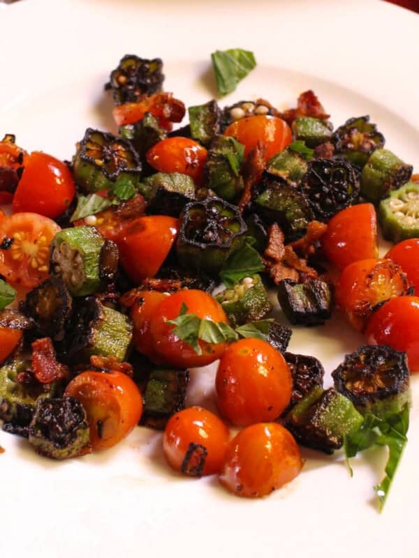 a single serving of pan fried okra and tomatoes on a plate.