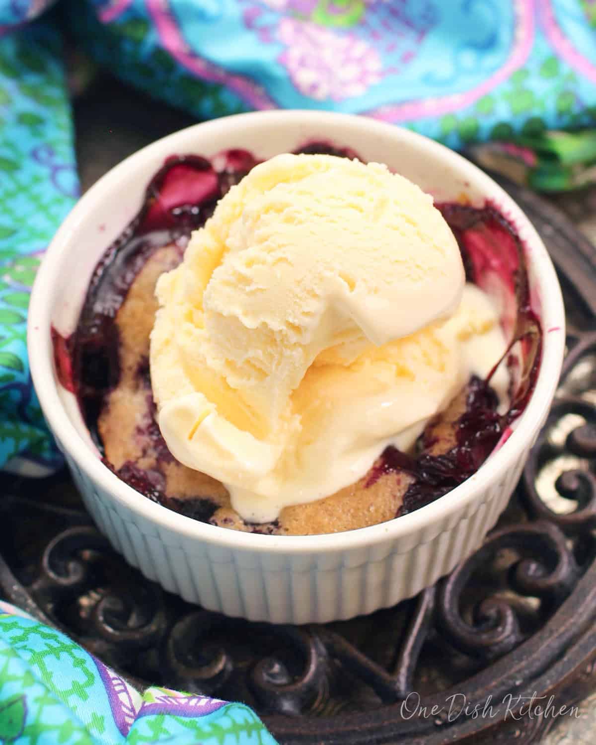 a small blueberry cobbler topped with ice cream.