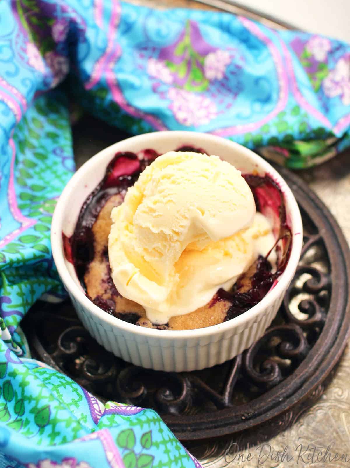 a small blueberry cobbler topped with ice cream.