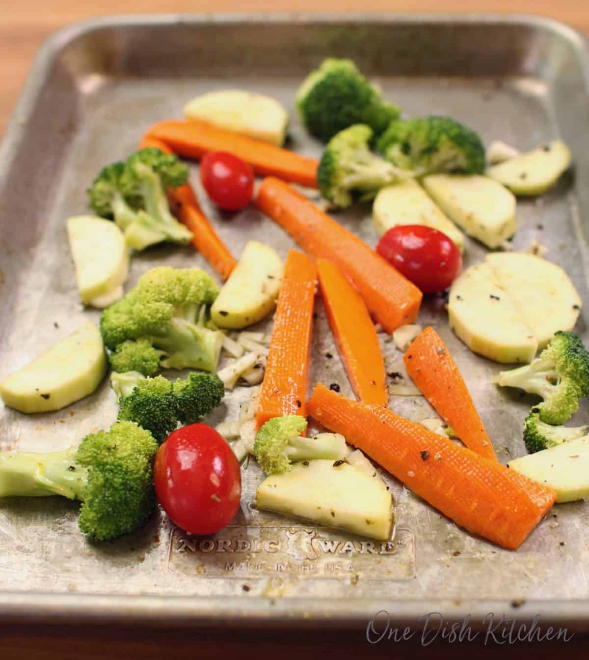 a small rimmed baking sheet filled with sliced vegetables.