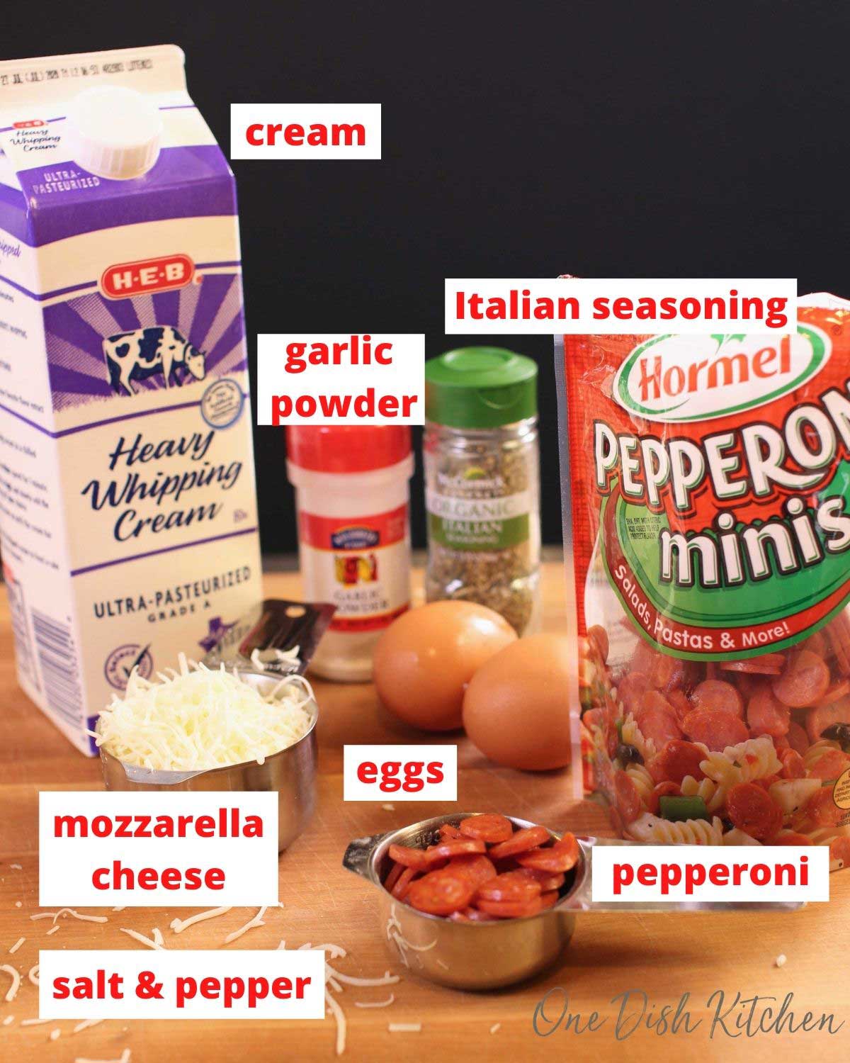 cream, pepperoni, mozzarella, seasonings, and eggs on a brown table.