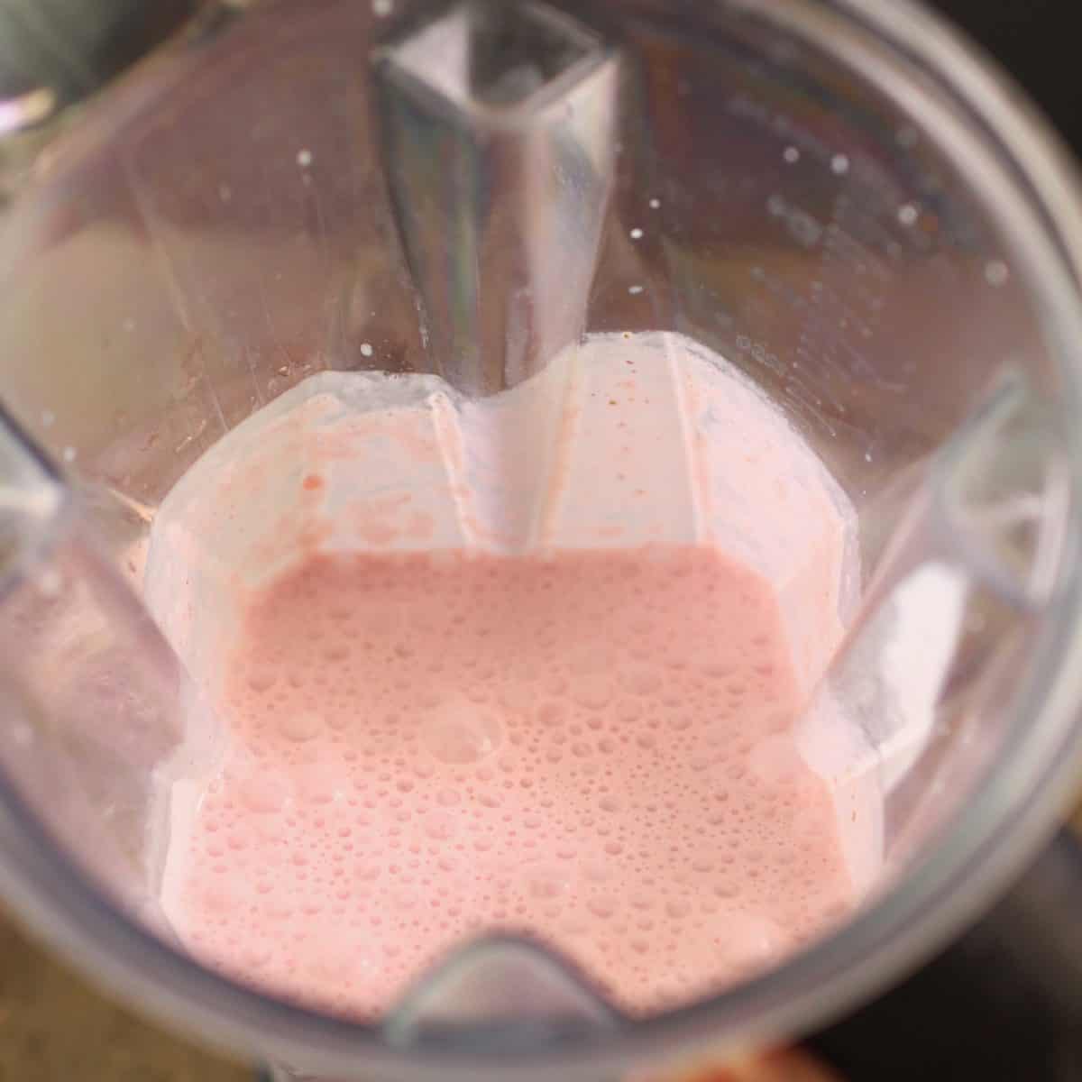 ingredients for a milkshake in blender pureed.