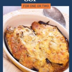 baked eggplant topped with melted cheese in a baking dish.