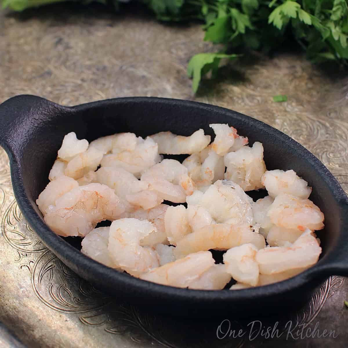 shrimp in a cast iron baking dish.