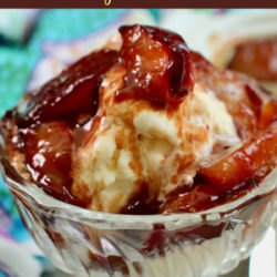 Caramelized plums over vanilla ice cream in a dessert glass.