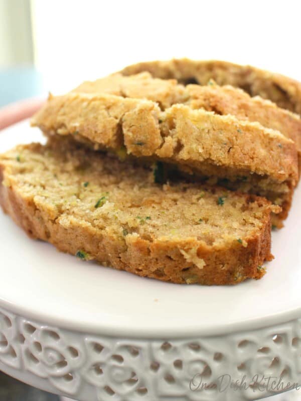slices of zucchini bread on a white cake stand.
