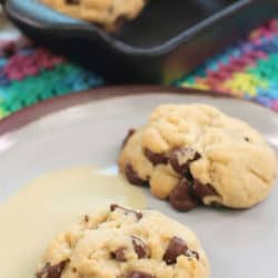 Two eggless chocolate chip cookies on a white plate