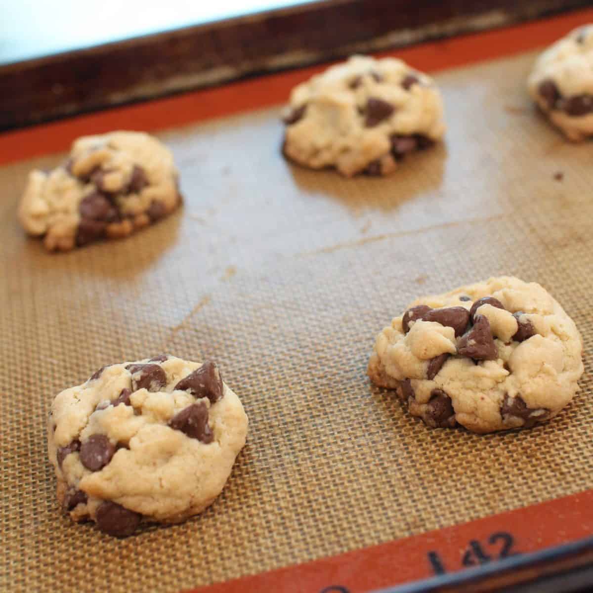 chocolate chip cookies on a silpat lined baking sheet.