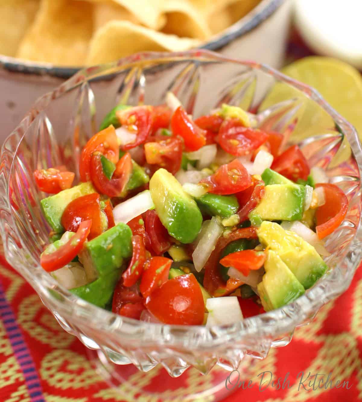 a single serving of pico de gallo with tomatoes, onions, jalapenos and lime juice in a bowl.