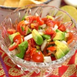 a single serving of pico de gallo with tomatoes, onions, jalapenos and lime juice in a bowl.
