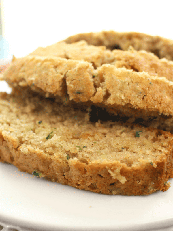 slices of zucchini bread on a white cake stand.