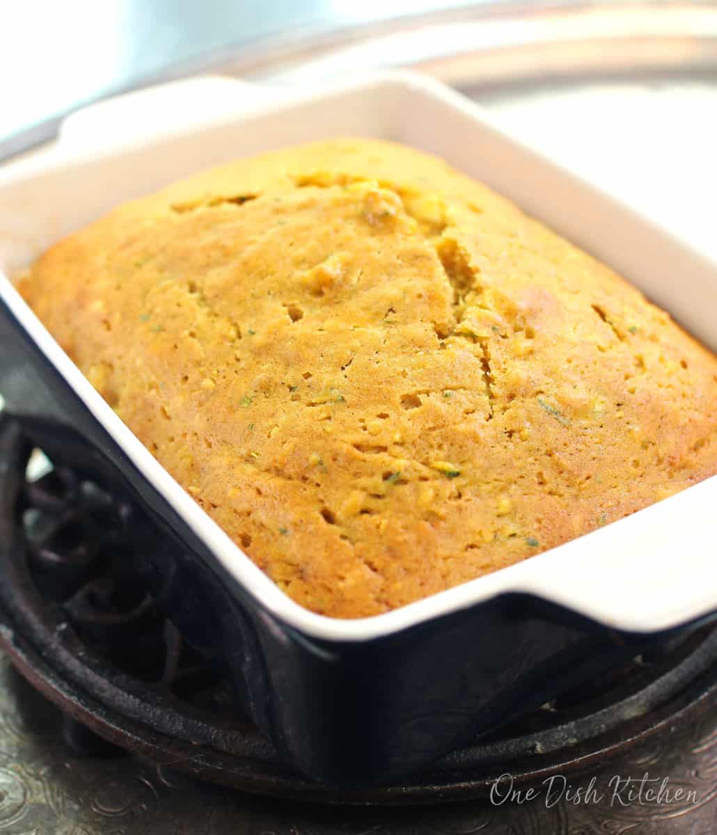 a mini loaf of zucchini bread on a silver tray.