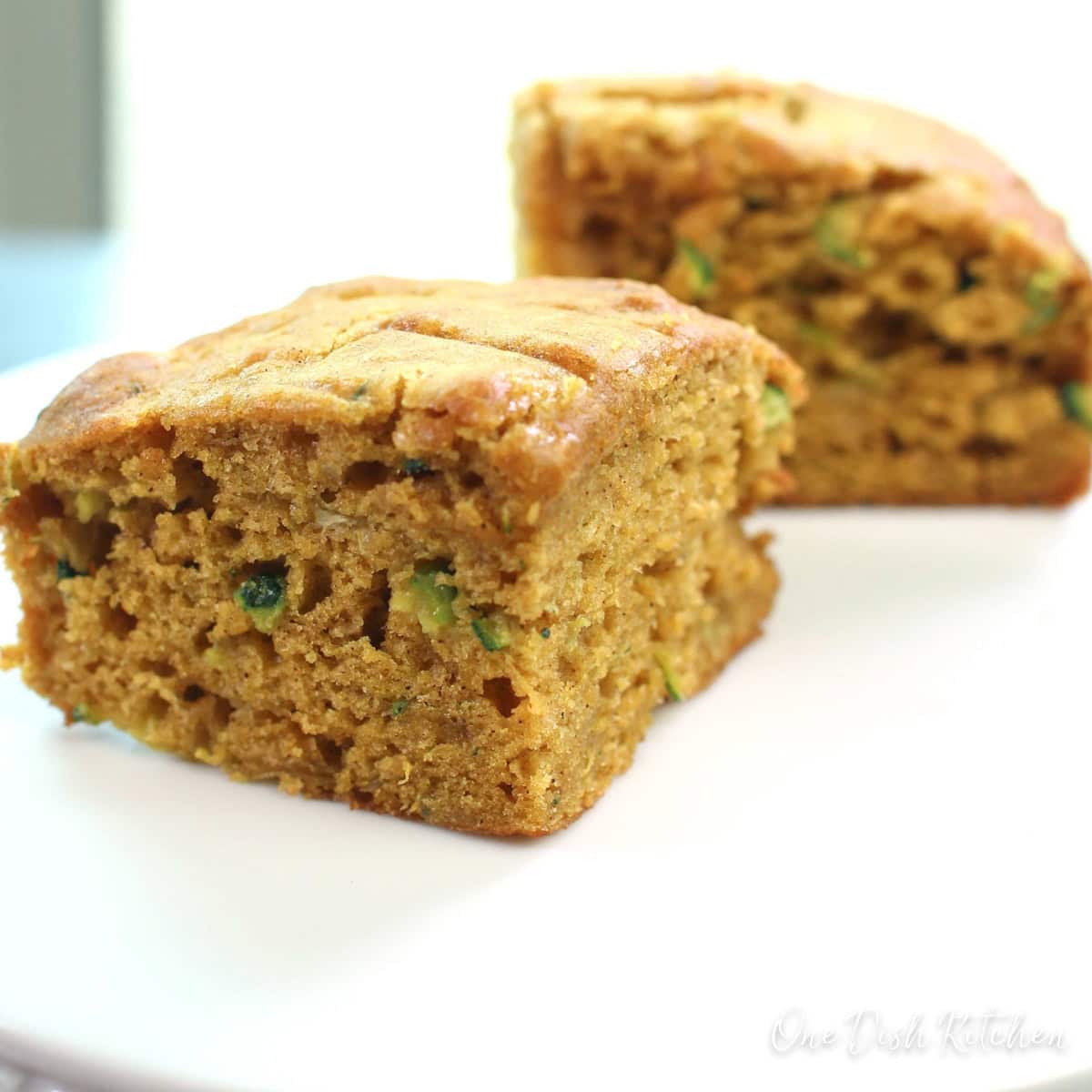 Two pieces of zucchini bread on a plate.