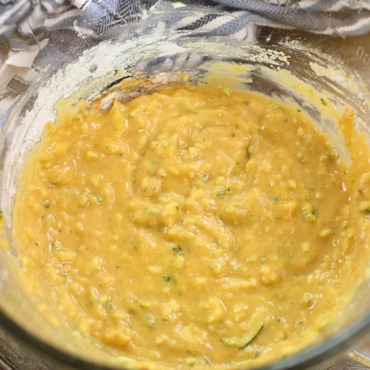 zucchini bread batter made with one zucchini in a mixing bowl.