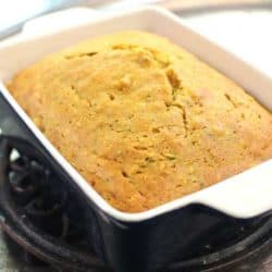 a loaf of zucchini bread on a silver tray.