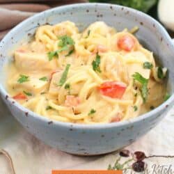 a bowl of chicken spaghetti on a table.