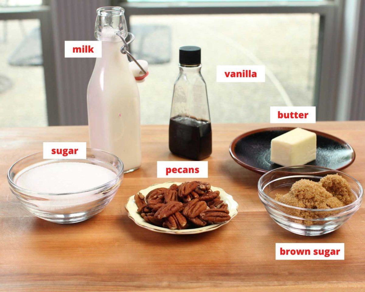 the ingredients needed to make pecan pralines on a brown table labeled.