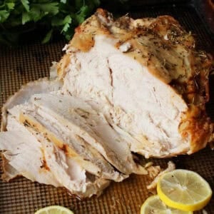 an oven roasted turkey breast on a baking sheet.