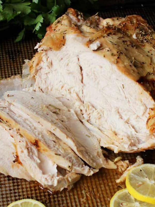 an oven roasted turkey breast on a baking sheet.