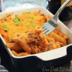 a single serving hamburger hot dish or hamburger casserole topped with cheddar cheese.